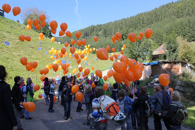 Schulklassen treffen sich vor dem Barbarastollen und lassen Luftballons fliegen